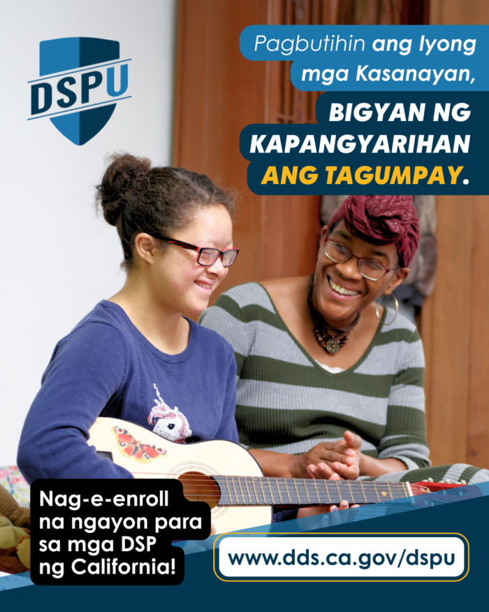 Ang isang direktang propesyonal sa suporta ang naghihikayat sa isang kabataang may kapansanan sa pag-unlad na tumutugtog ng gitara.